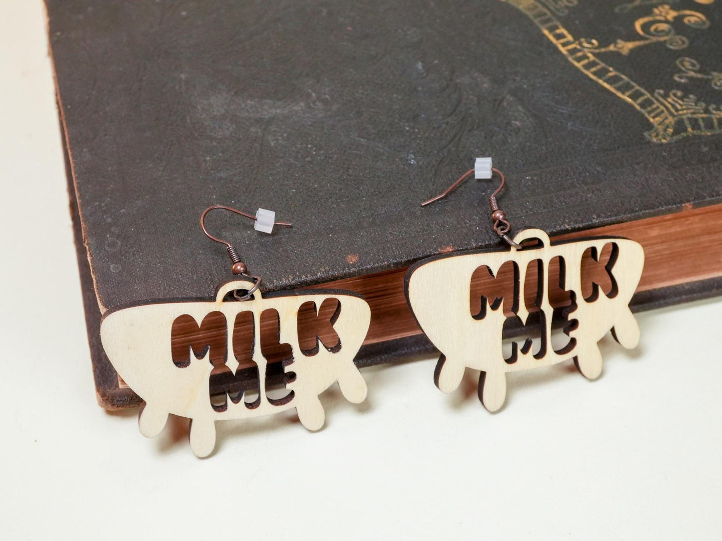 Bound by Dave wooden Hucow Earrings shaped like milk bottles with Milk Me cutout design