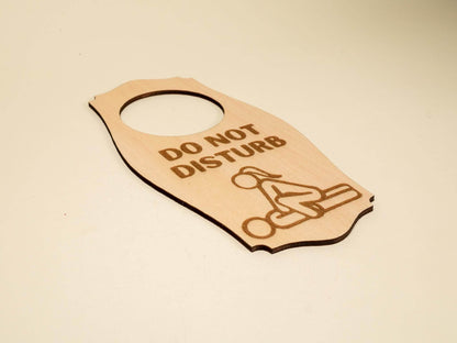 Wooden adult do not disturb sign with carved text and explicit design for privacy