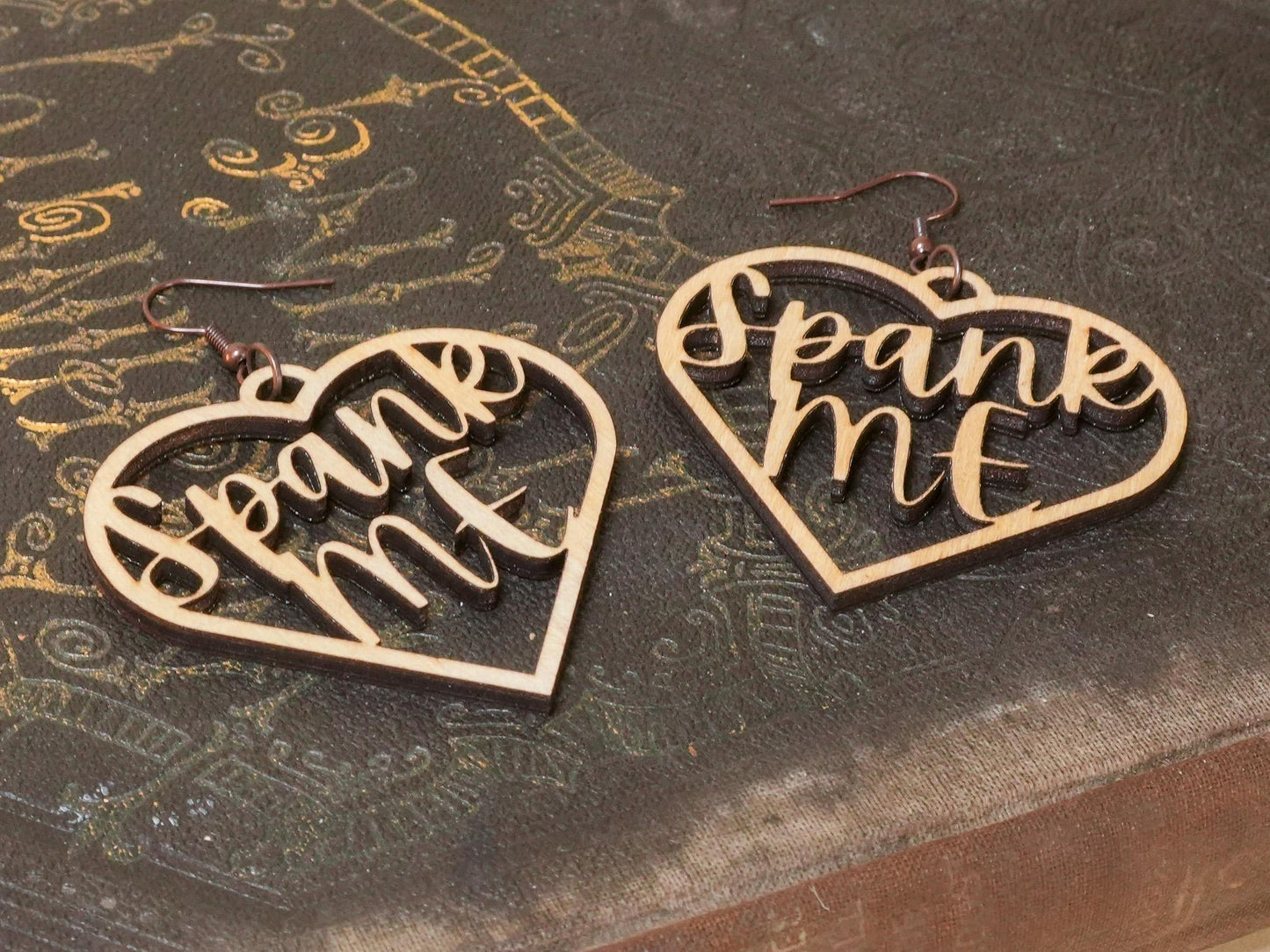 Bound by Dave heart-shaped wooden bdsm earrings with spank me cutout design