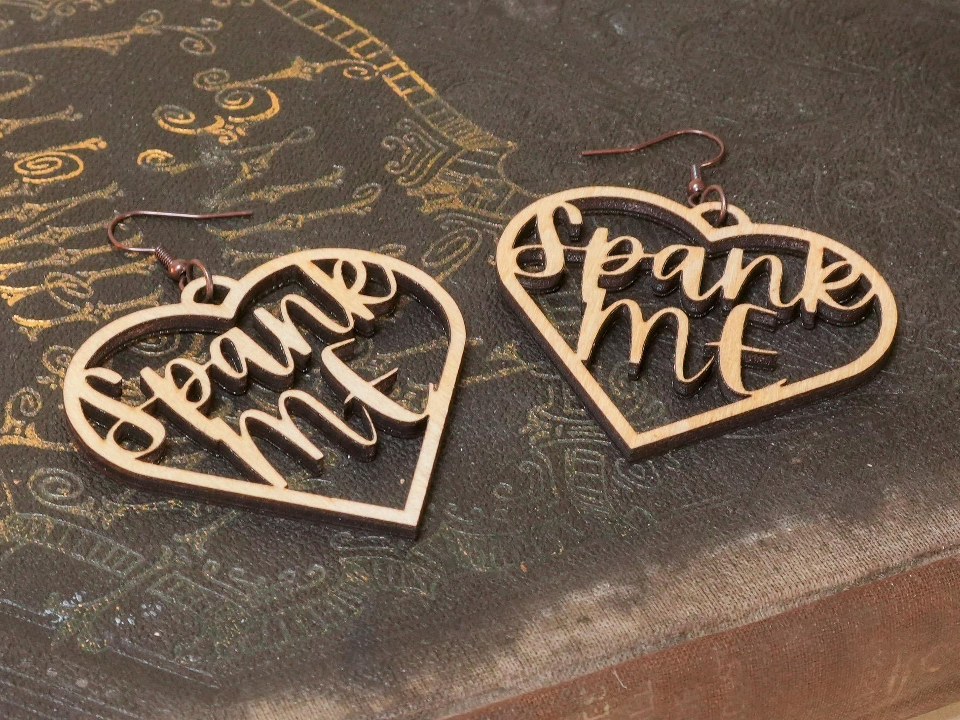 Bound by Dave heart-shaped wooden bdsm earrings with spank me cutout design