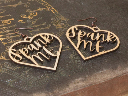 Bound by Dave heart-shaped wooden bdsm earrings with spank me cutout design