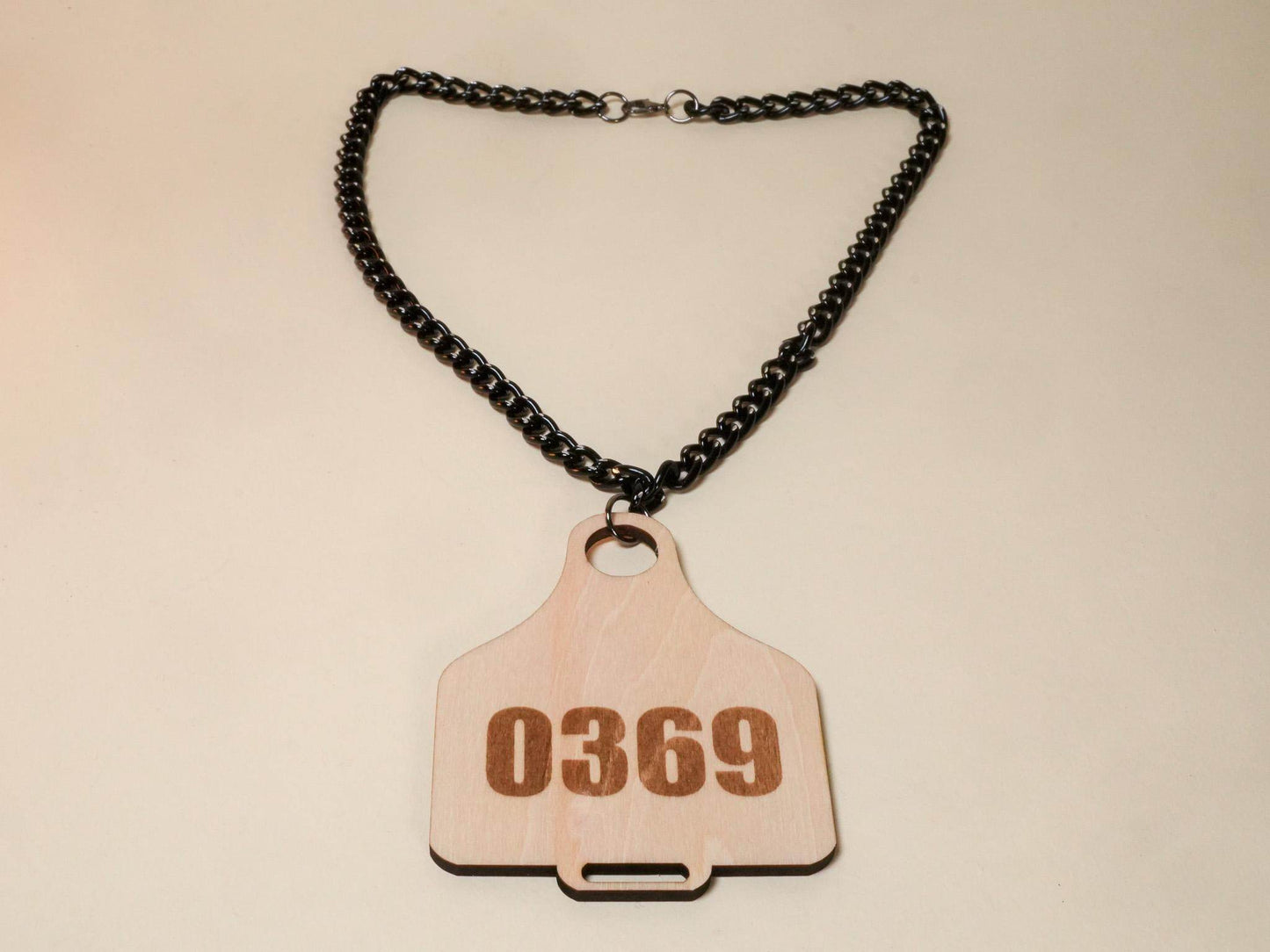 Bound by Dave wooden Cow Tag necklace with black chain and engraved number 0369