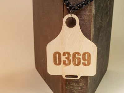 Bound by Dave wooden Cow Tag with number 0369 on a black chain necklace