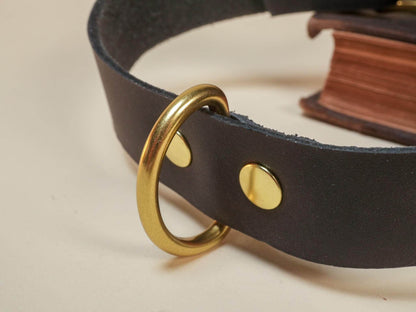 Bound by Dave black leather day collar with gold metal ring and rivets close-up view
