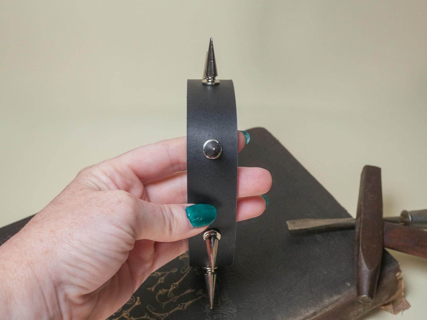 Bound by Dave black leather Goth Choker with metal spikes held by hand with teal nails