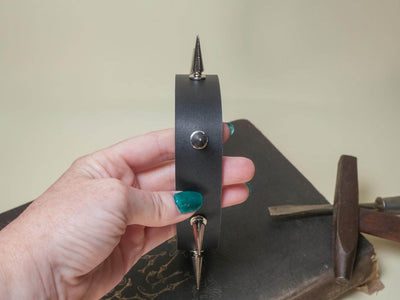 Bound by Dave black leather Goth Choker with metal spikes held by hand with teal nails