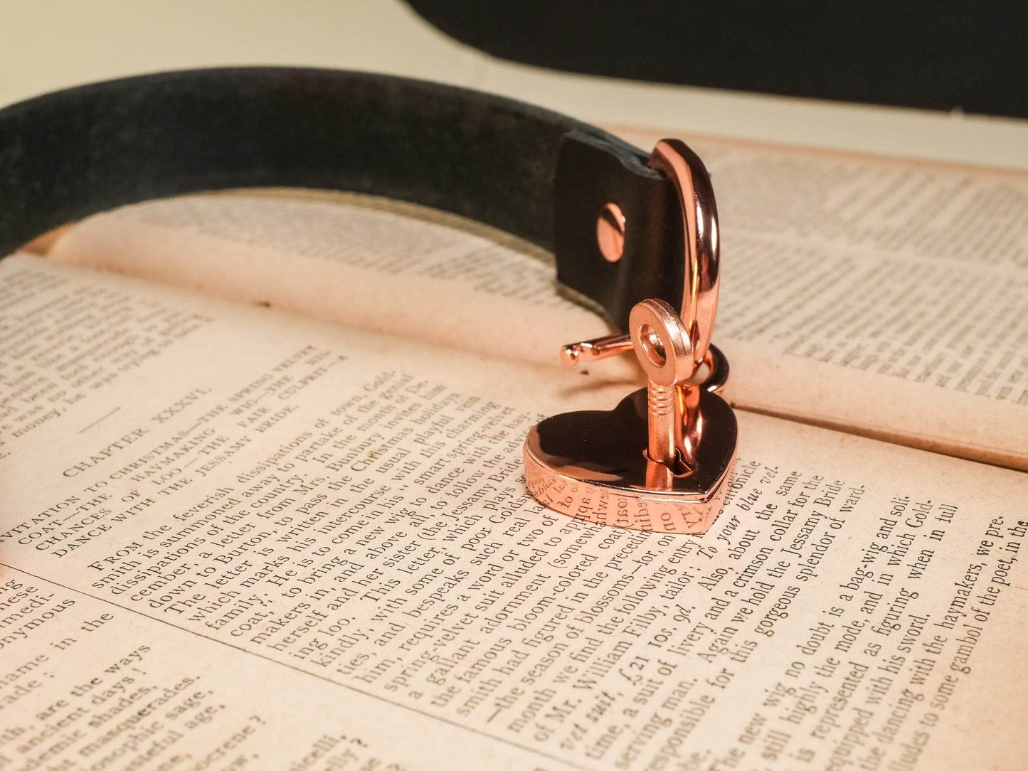 Heart Lock rose gold lock with key attached to a black leather strap by Bound by Dave