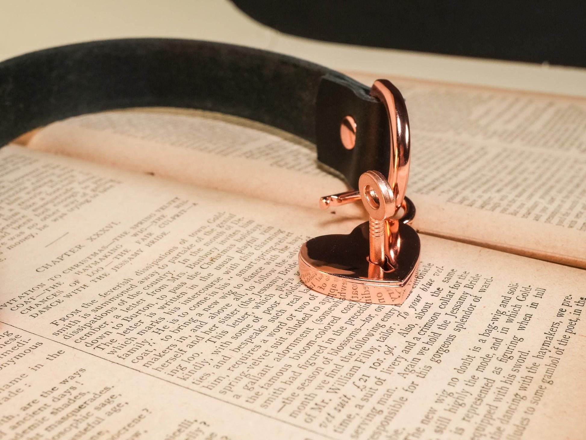 Heart Lock rose gold lock with key attached to a black leather strap by Bound by Dave