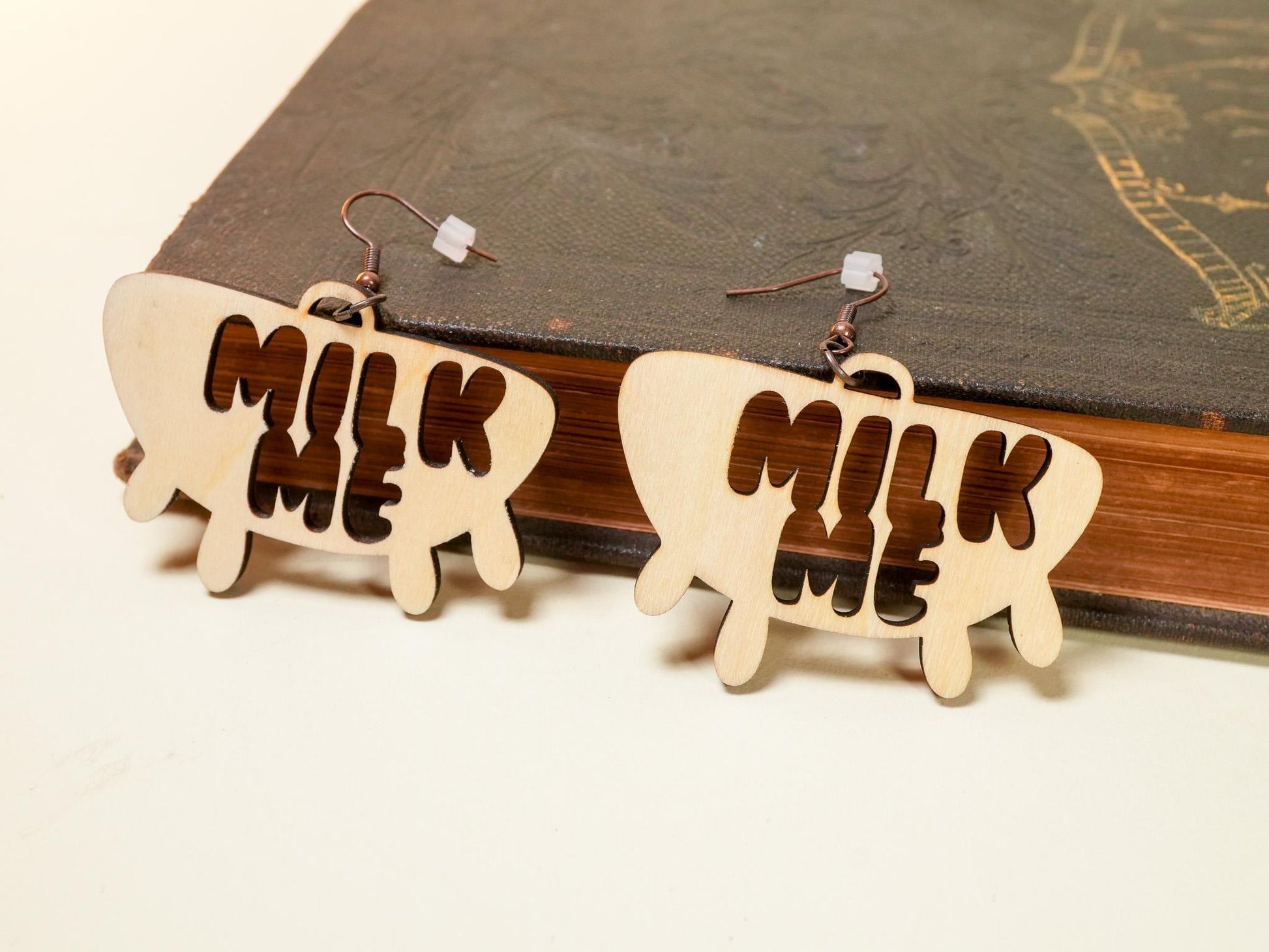 Bound by Dave wooden Hucow Earrings shaped like udders with milk me cutout design