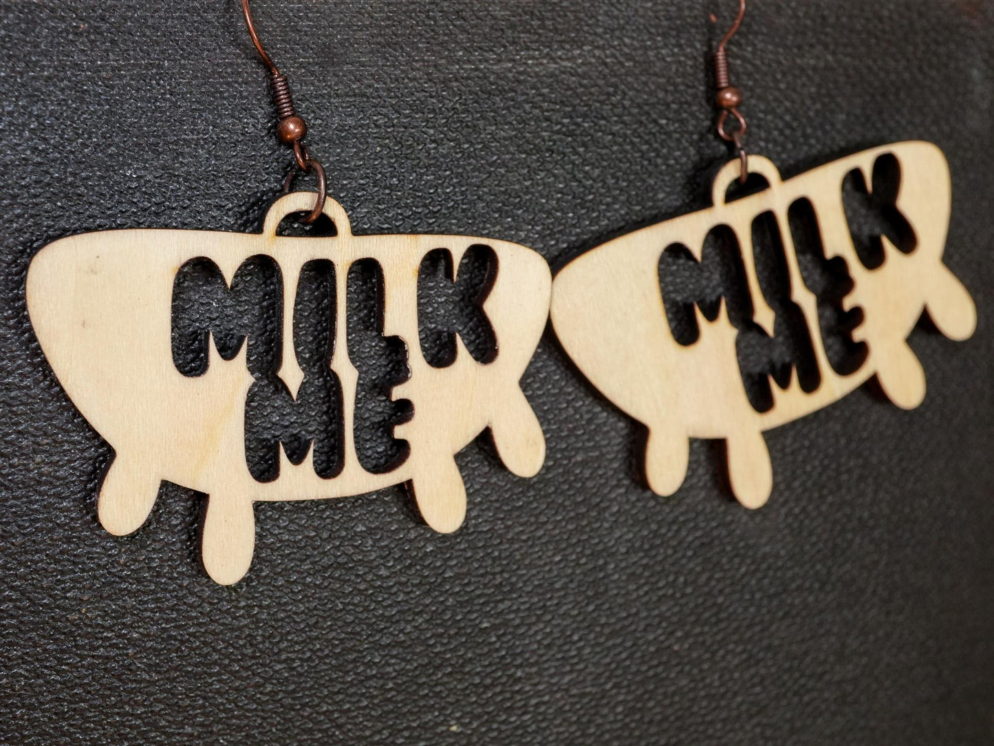Wooden Hucow Earrings with milk me cutout design and rustic metal hooks by Bound by Dave