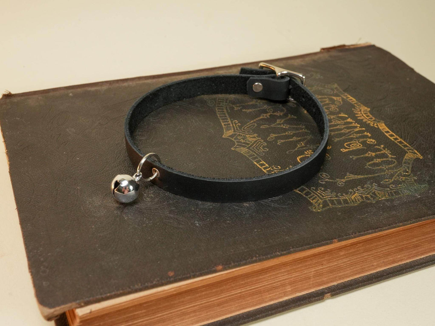 Black leather kitten collar with small silver bell and buckle from Bound by Dave