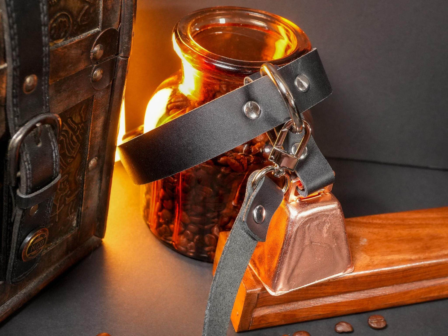 Bound by Dave black leather Locking Collar with metal hardware and attached bell on wooden surface