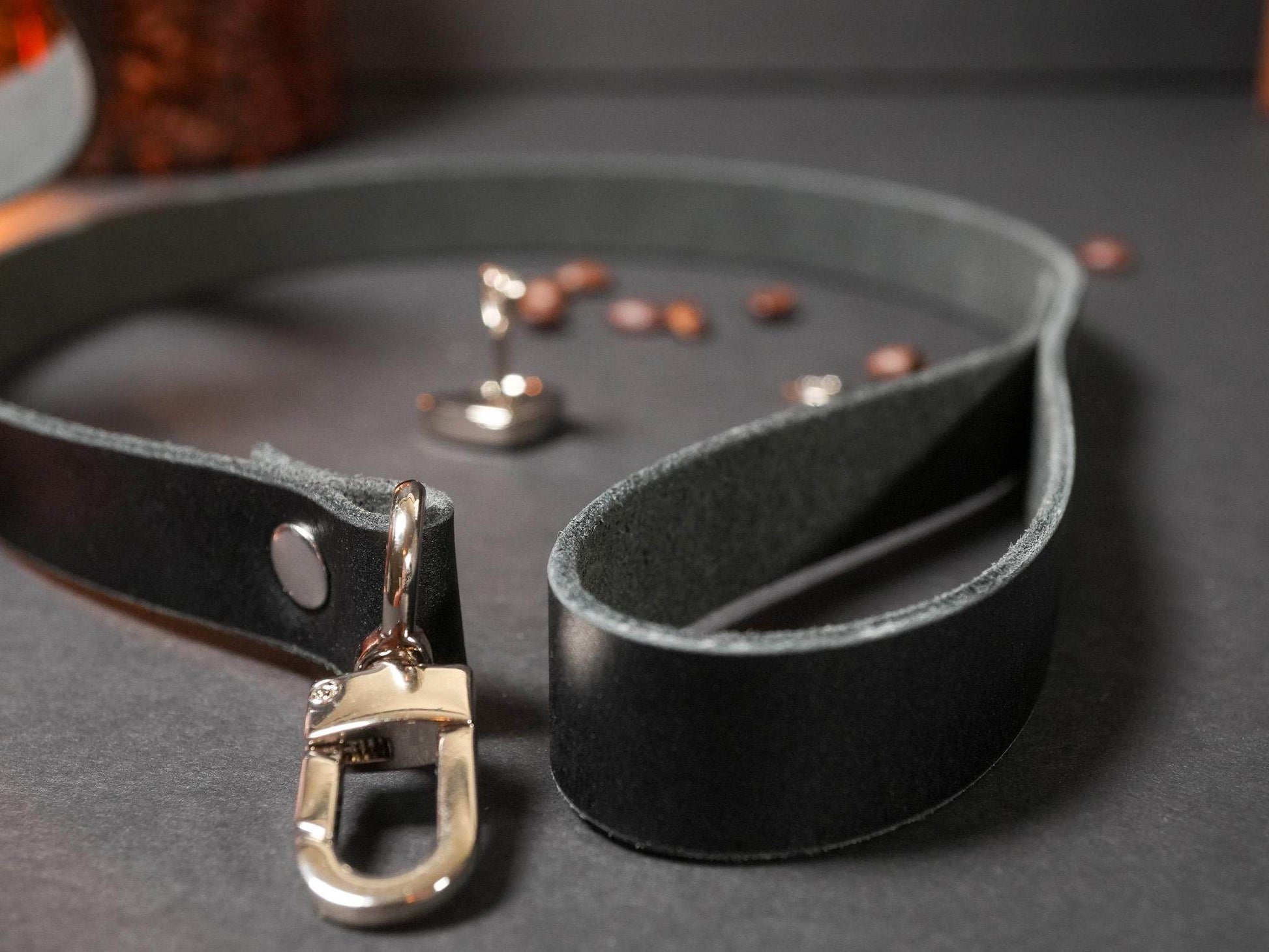 Black leather Locking Collar with metal clasp from Bound by Dave on dark surface