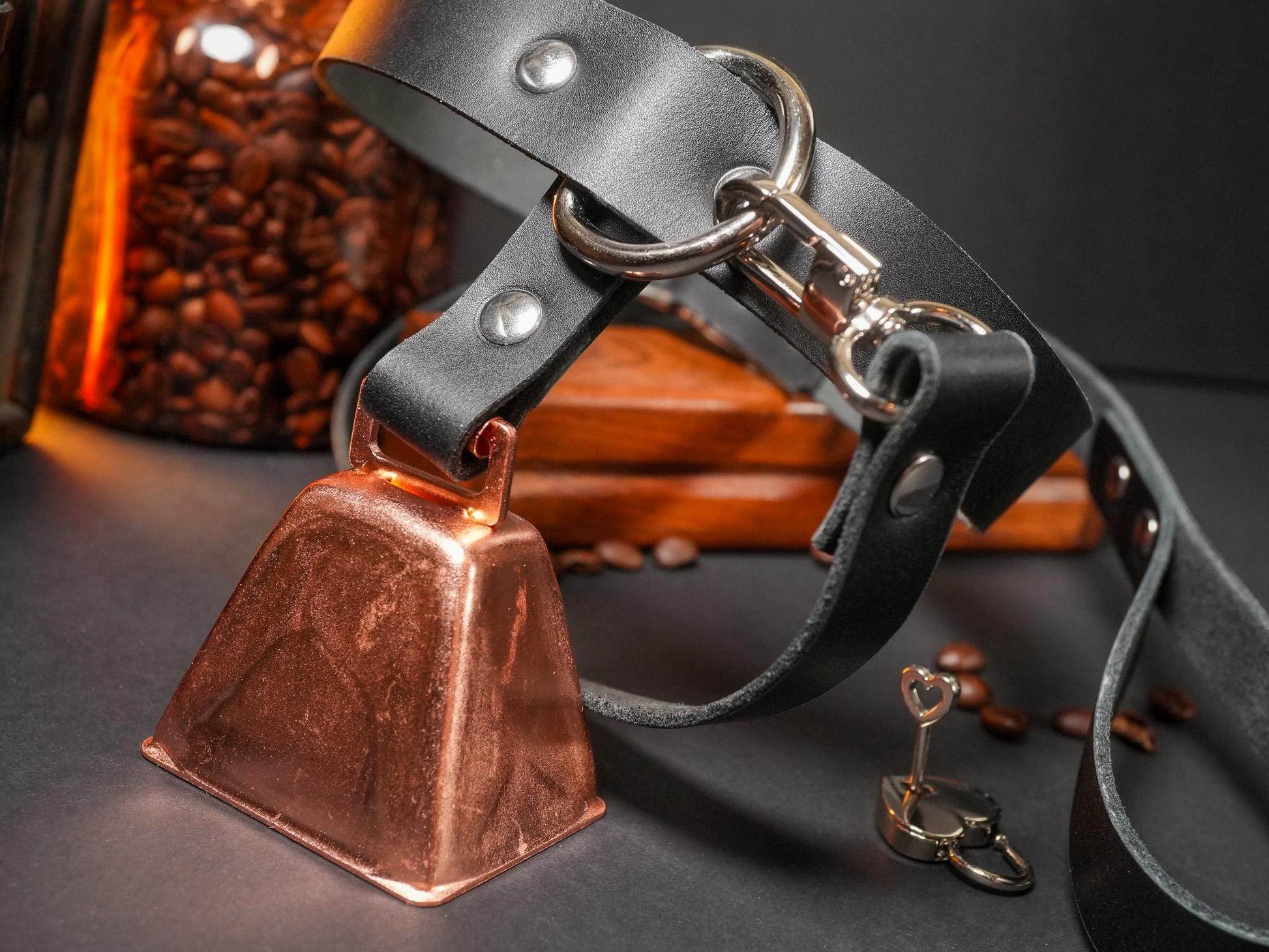 Bound by Dave locking collar with black leather strap and attached copper cowbell with small metal key