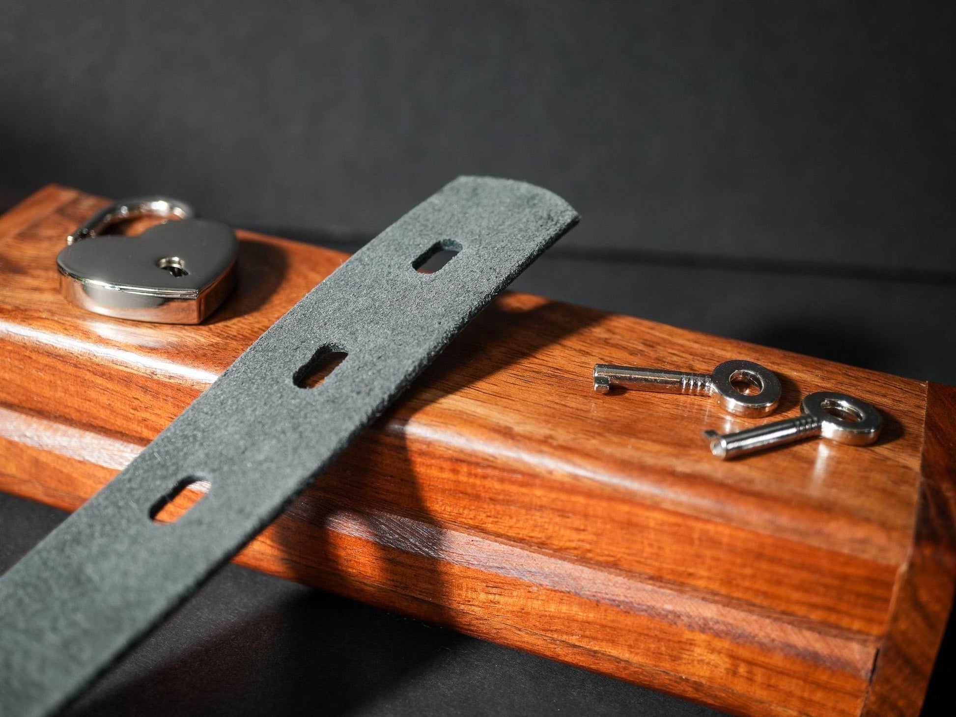 Bound by Dave Locking Sub Collar with grey strap, metal lock, and two keys on wooden box