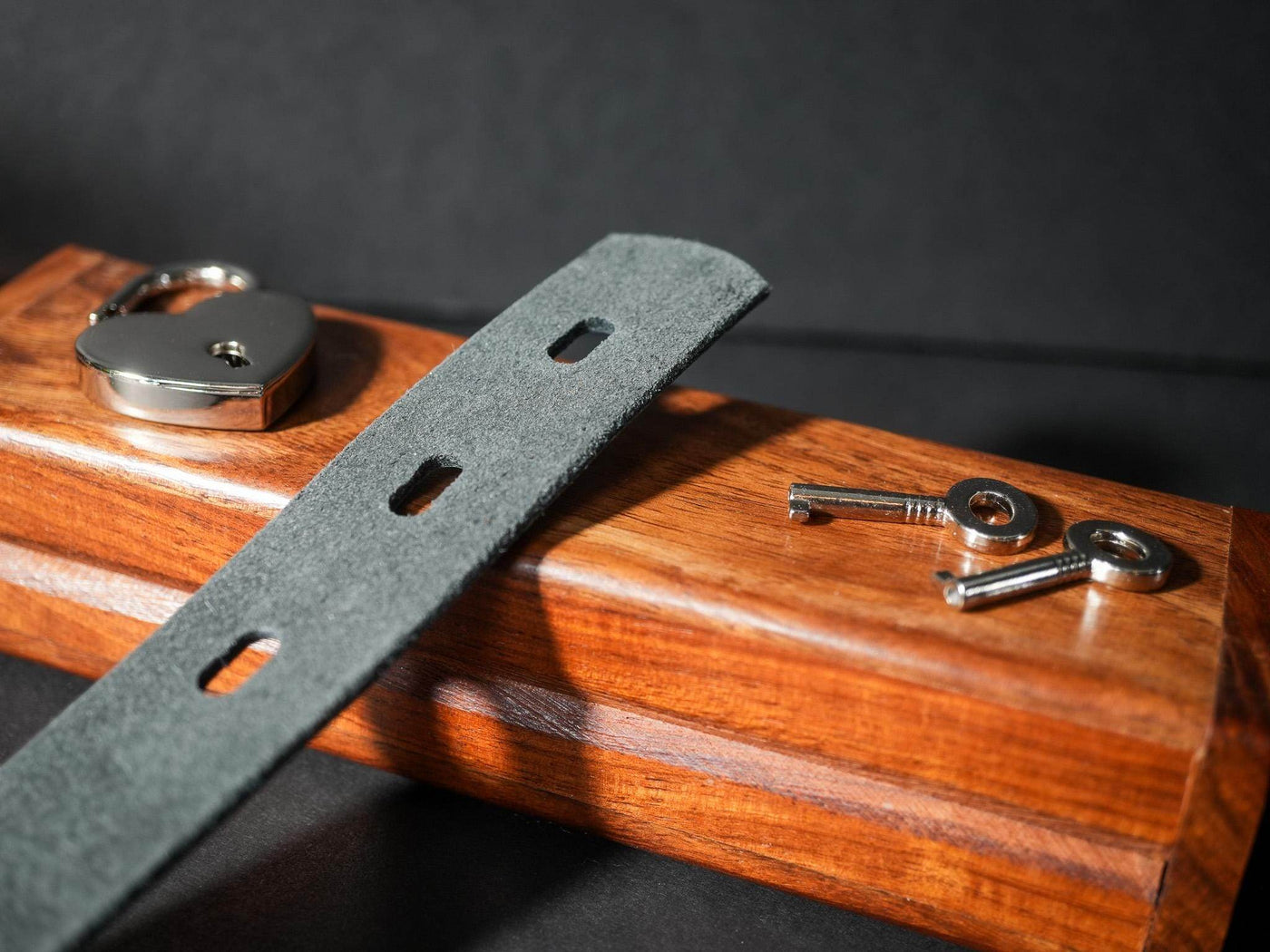Bound by Dave Locking Sub Collar with grey strap, metal lock, and two keys on wooden box