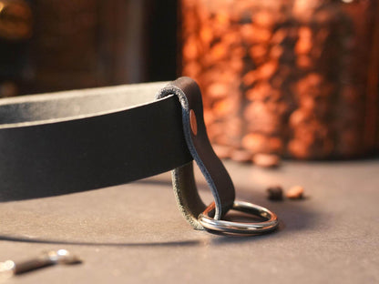 Bound by Dave Locking Sub Collar made of black leather with sturdy metal ring on table