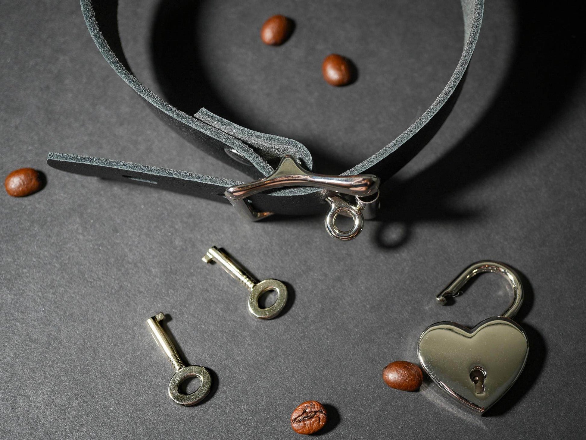 Bound by Dave Locking Sub Collar in gray leather with heart-shaped padlock and two keys on gray background