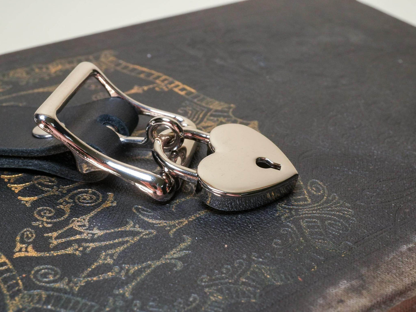 Bound by Dave Locking Sub Collar with heart-shaped lock on black textured surface