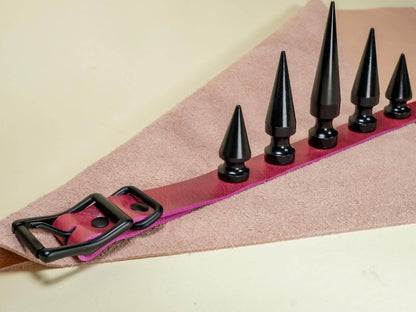 Bound by Dave black spike leather Rave Choker with adjustable buckle on pink fabric background