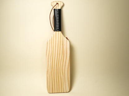 Wooden Spanking Paddle with black wrapped handle and leather wrist strap by Bound by Dave
