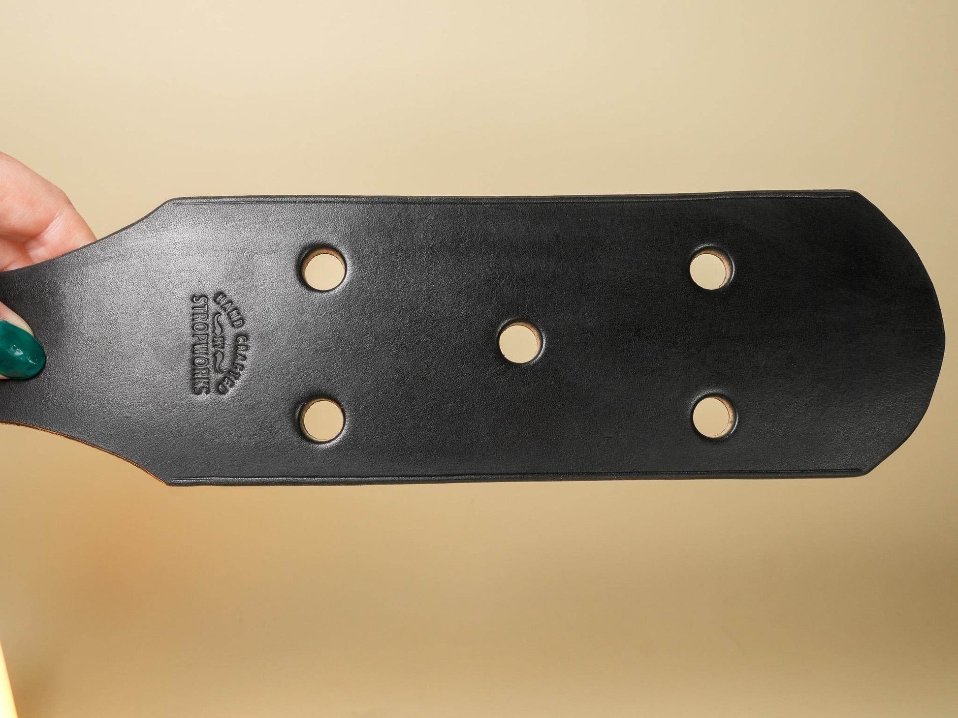 Bound by Dave black leather paddle with five leather paddle holes visible and smooth finish