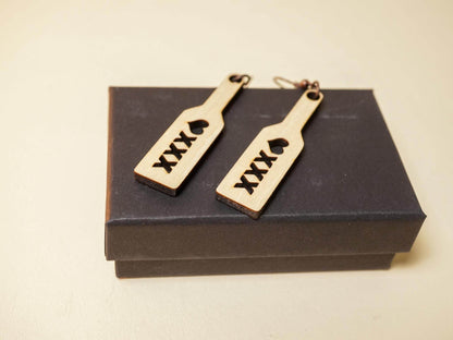 Wood spanking paddle earrings engraved with XXX and heart design on black box
