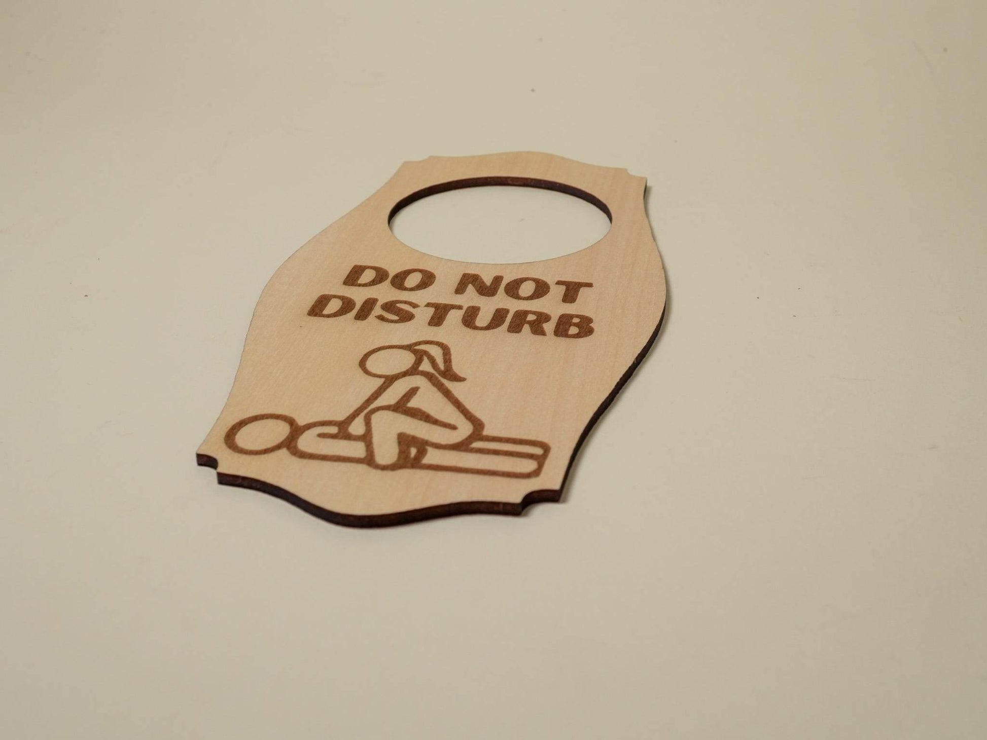 Wooden adult do not disturb sign with engraved couple illustration and do not disturb text