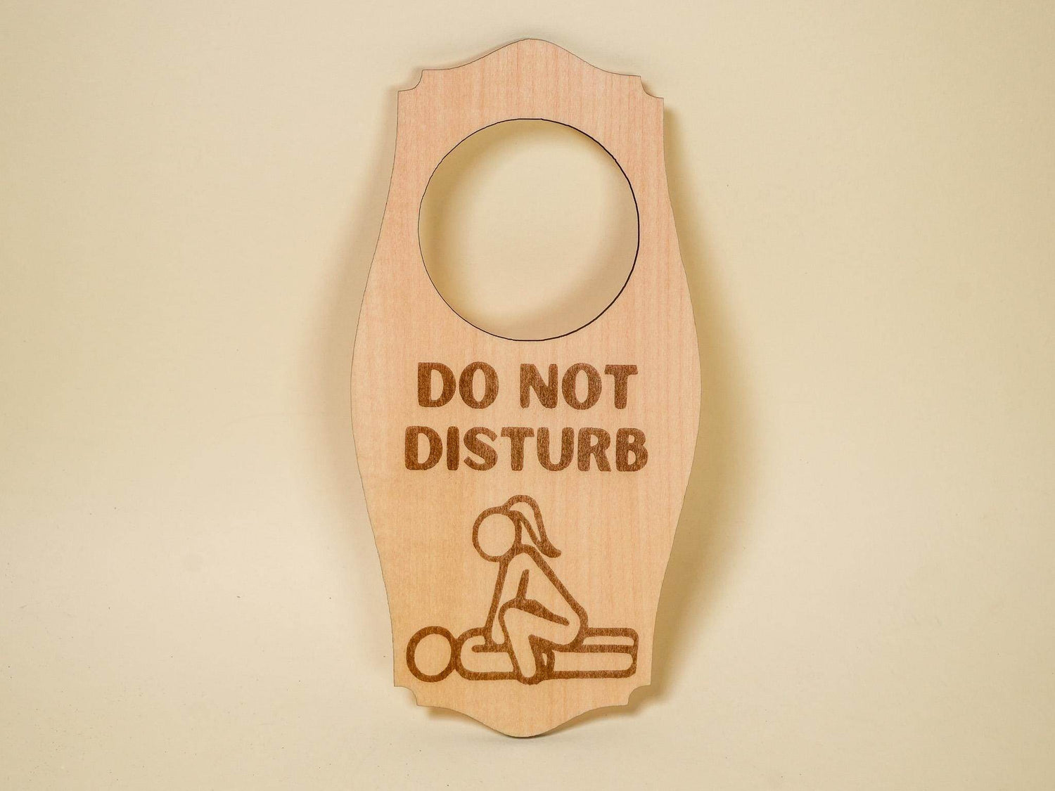 Wooden adult do not disturb sign with engraved text and playful silhouette design